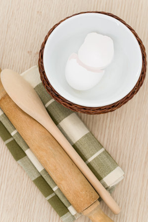 natural wood kitchen utensils and a table napkin on a wooden background with copy spaceの写真素材