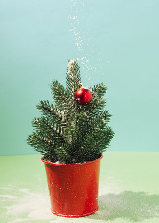 New Year, snowing on the Christmas tree, green-blue backgroundの写真素材