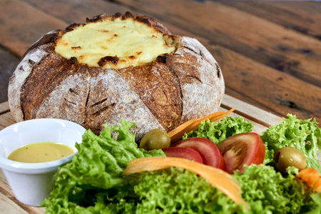 peasant bread stuffed with meat and chicken covered with cheese with salad, vegan