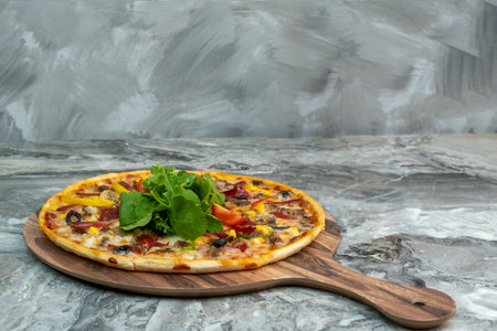 Delicious pizza served on wooden plate.  Top viewの写真素材