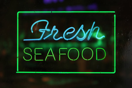 Vintage Neon Fresh Seafood Sign in Rainy Windowの写真素材
