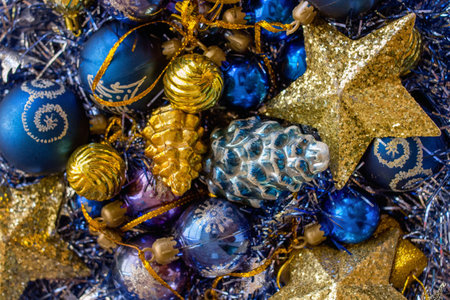 Gold and blue Christmas decorations on silver and blue background - topview