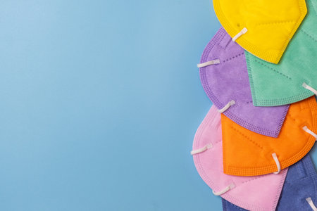 Top view of a table with colorful face masks piled and space to copy