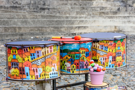Ethnic and colorful decorated set of drums hand made painted on the streets of Pelourinho, Salvador, Bahiaの写真素材