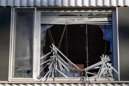 broken window with Venetian blind