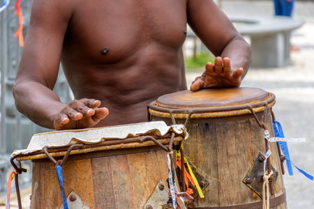 Musician playing atabaque which is a percussion instrument of African origin used in samba, capoeira, umbanda, candomble and various cultural, artistic and religious manifestations in Brazilの写真素材