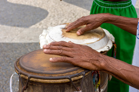 Percussionist playing a rudimentary atabaque during afro-brazilian cultural manifestation at Pelourinho on Salvador city, Bahiaの写真素材