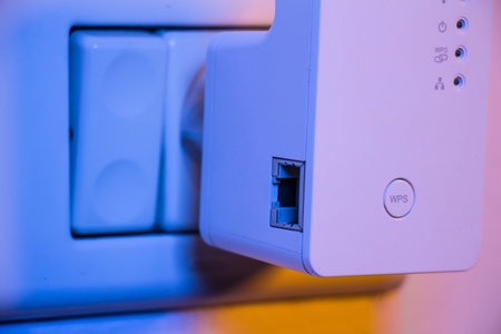 WiFi repeater in electrical socket on the wall. Device that help to extend wireless network in home or office.の写真素材