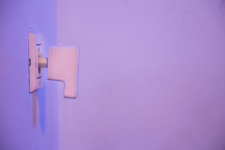 WiFi repeater in electrical socket on the wall. Device that help to extend wireless network in home or office.の写真素材
