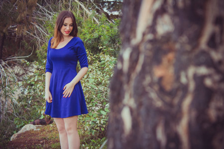 Beautiful young brunette woman posing outdoor at the forest.の写真素材