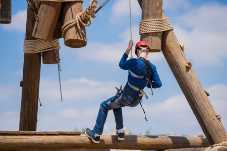 Extreme professional videographer during shooting on climbing tower working under extreme conditions. He has a DSLR camera and an action camera.の写真素材