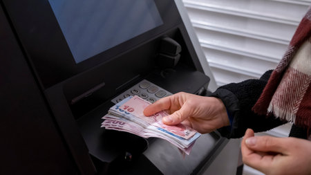 Woman withdrawing money from a cash machineの写真素材