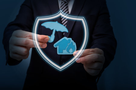 Fire insurance concept: paper house and umbrella.の写真素材