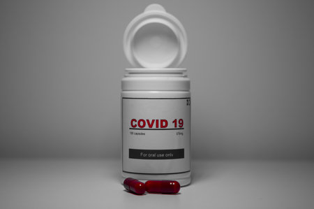 A white bottle of covid-19 antiviral pills in the laboratory. Concept of the new antiretroviral...
