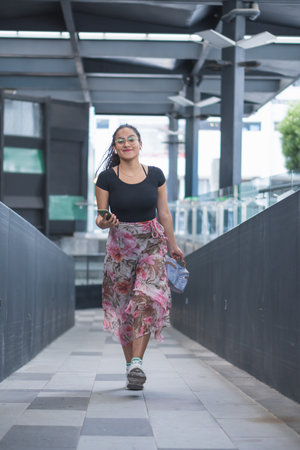 Young woman walking through the city. Enjoying a great day doing different activities.