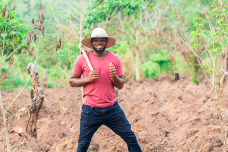 portrait of an african farmer doing thumbs upの写真素材