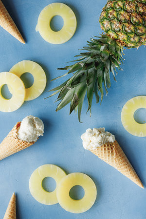 pineapple ice cream in the horn lie on the pineapple rings, in the frame are three horns, not peeled...