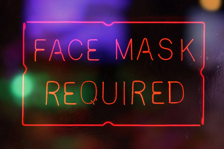 Neon Face Mask Required Sign in Rainy Windowの写真素材