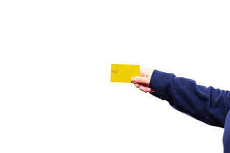 Unrecognizable woman holding credit card on white background. Woman hand holding credit card on white background.の写真素材