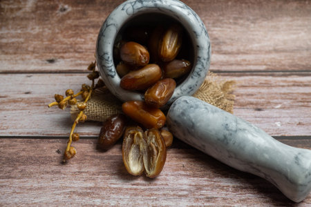 bunch of fresh dates and walnuts in a ceramic storage box