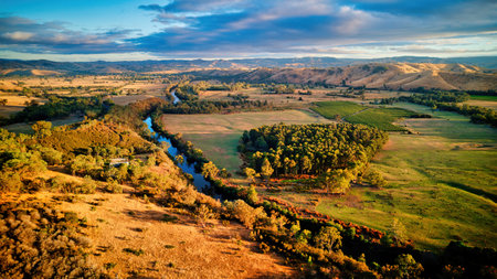 Early morning light over the hills, farmland and Goulburn River between Taggerty and Alexandra in...