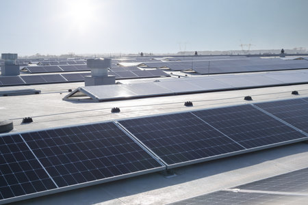 Group of solar panels on roof, sunny weather. Large number of solar panels on roof.