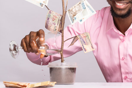african man waters a money treeの写真素材