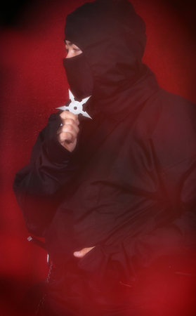 Asian Man Wearing Ninja Costume and holding Weaponsの写真素材