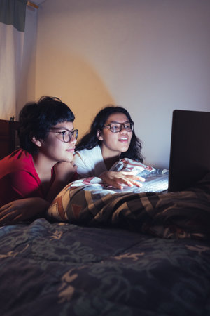 Young women at a sleepover watching movies.