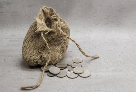 a sack with 30 pieces of silver, symbol of the betrayal of Judas on a gray background