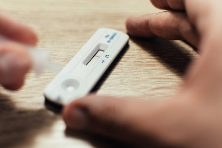 The man does the covid-19 antigen rapid pcr test. The test returned a negative result.の写真素材