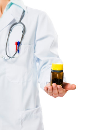 healthcare and medicine: doctor with bottle of pills in her handの写真素材
