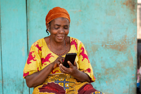 elderly african woman using her smartphoneの写真素材