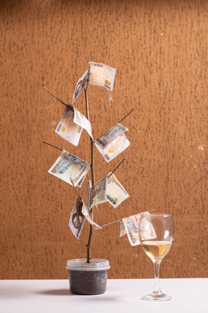 a money tree and a glass of wine