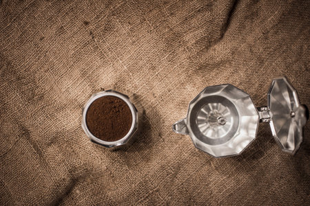 Grinded coffee in aluminium espresso coffee maker pot. Close-up and detail with selective focus.の写真素材