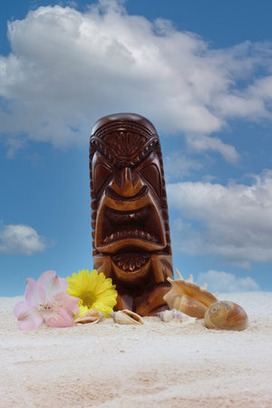 Antique Mask From Hawaii on Beach With Flowers and Blue Skyの写真素材