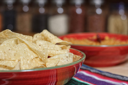 Fresh Bowl of Mexican Rice With Spicy Peppers With Jars of Rice in Background Shallow DOF