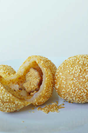 Dim-sum pastries made with a sticky rice flour dough, filled with a sweet paste, rolled in sesame...