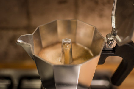 Percolated espresso coffee in a stovetop coffee maker. Close-up and detail with selective focus.の写真素材