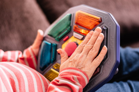 Woman playing board games to exercise her memory. Unrecognizable woman playing follow the lights,...