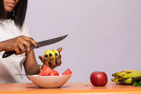 african lady cutting up some fruits