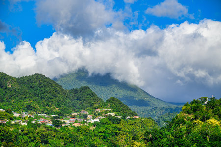 A view of the coast of Dominica and the jungle under a blue sky with beautiful clouds