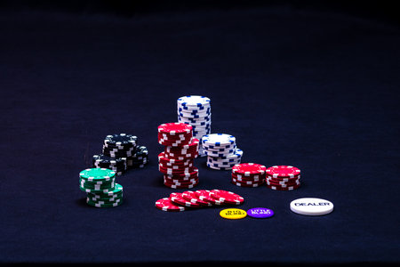 Stack of poker chips on black background