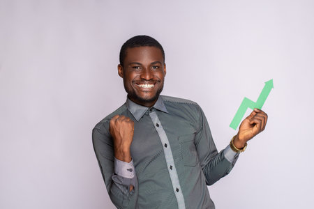 excited african man holding an upward graph symbol