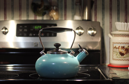 Old Blue Tea Kettle on Kitchen Stove Ready for Useの写真素材