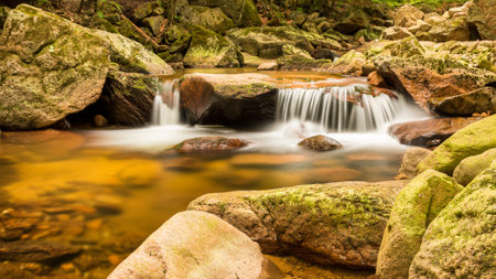 Ilse waterfall in the Harz Mountains with rock formation. Autumn mood