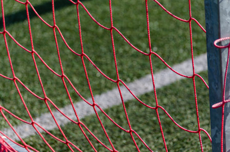 red netting of a football goal of an artificial turf fieldの写真素材