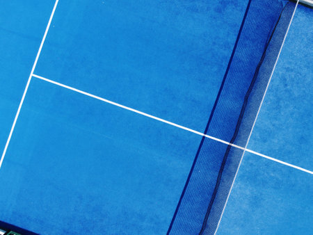 aerial view of a blue artificial grass paddle tennis court