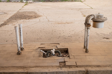 Piping from a gas pump ripped off at an abandoned gas station. Crisis fuel concept