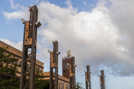 lighting towers blue sky background with clouds